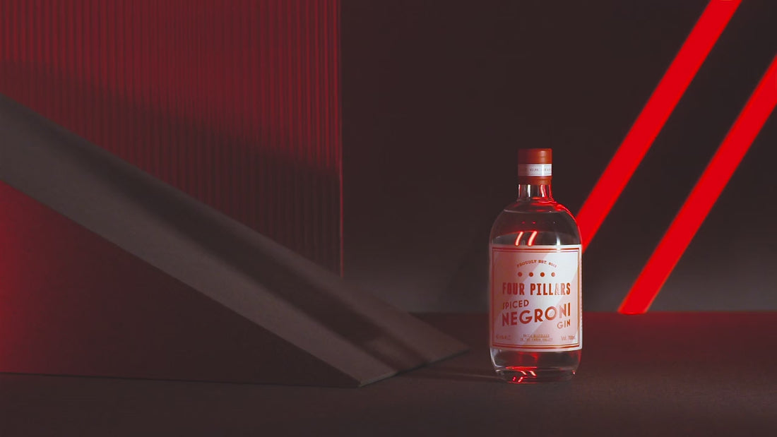 A video of Four Pillar's Gin's Spiced Negroni Gin surrounded by moody reds as a light pans across it. 